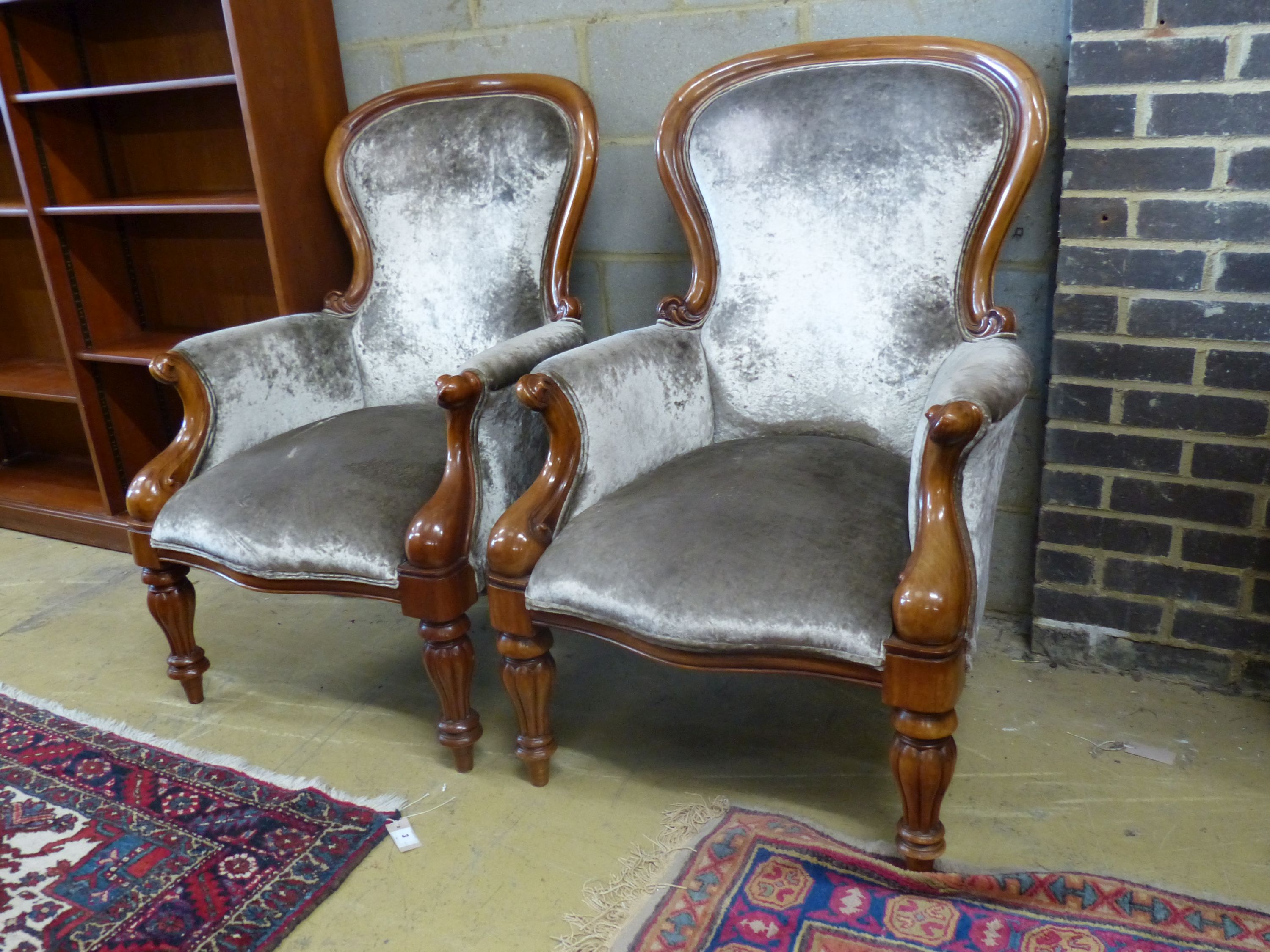 A pair of reproduction Victorian style mahogany spoonback armchairs, width 71cm depth 80cm height 108cm